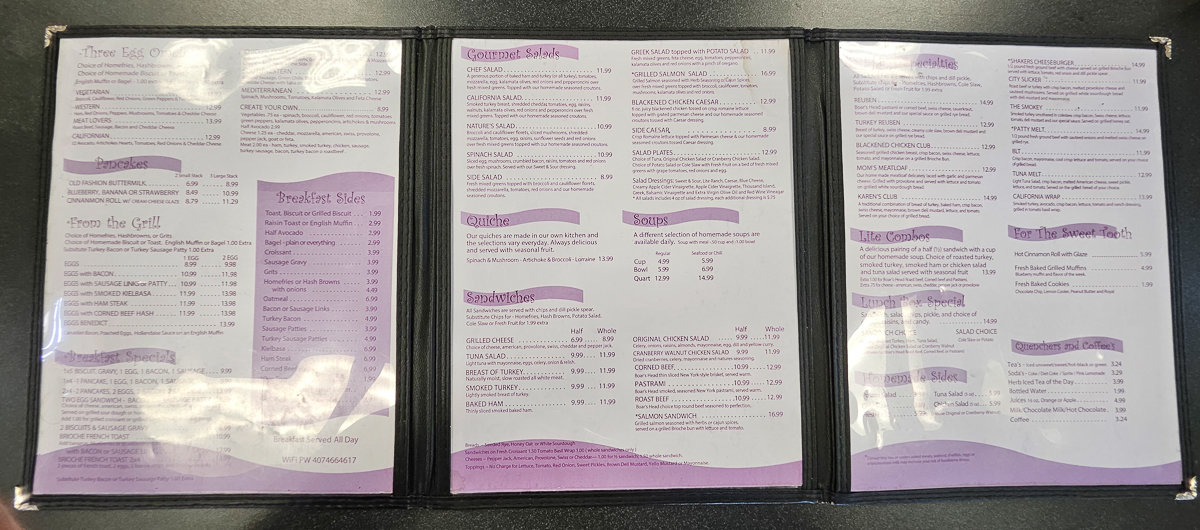 white and purple menu in a plastic cover